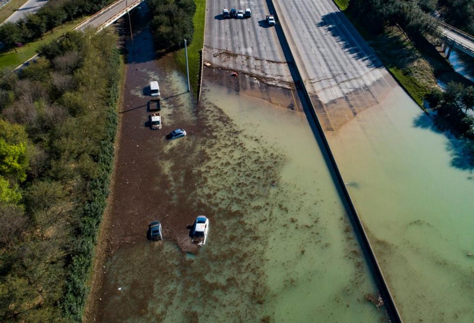 In this aerial photo, water is slowly draining from the freeway after a water main break east of the location flooded all lanes, closing the freeway in both directions, at the intersection of 610 and Clinton Drive in east Houston. Businesses and schools shut down after a main line from a plant that supplies water to about half of Houston burst open, submerging vehicles on the flooded freeway.  Thursday, Feb. 27, 2020