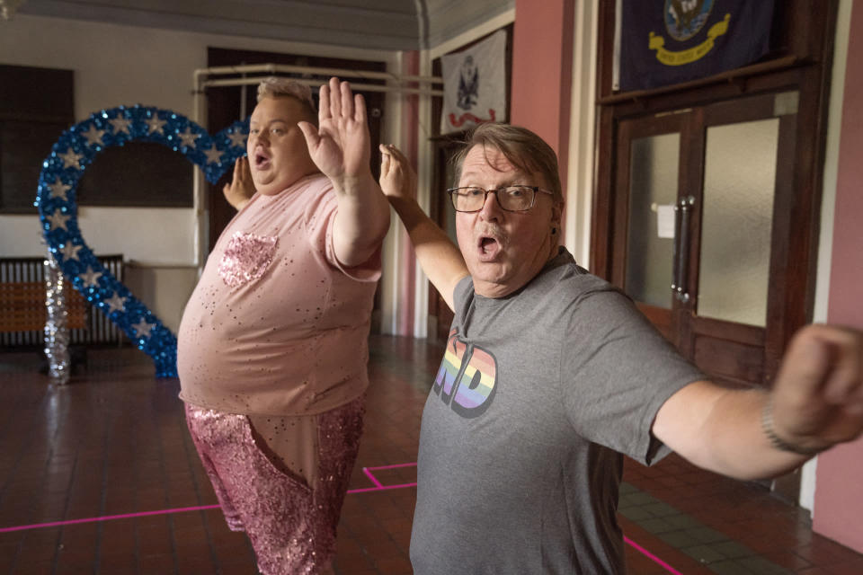 This image released by HBO shows Eureka O'Hara, left, and Pastor Craig Duke, of Newburgh, Ind., in a scene from the HBO series "We're Here." Duke’s pastoral duties have been terminated – the result of a bitter rift surfacing in his Indiana church after he sought to demonstrate solidarity by appearing in drag alongside prominent drag queens in the reality show. (Jakes Giles Netter/HBO via AP)