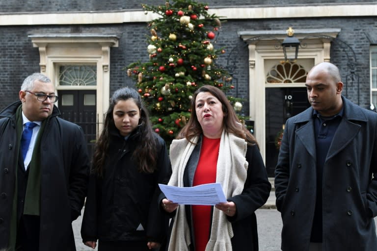 Sandra Ruiz (second from the right), who lost her niece in the fire, holds the petition outside 10 Downing Street