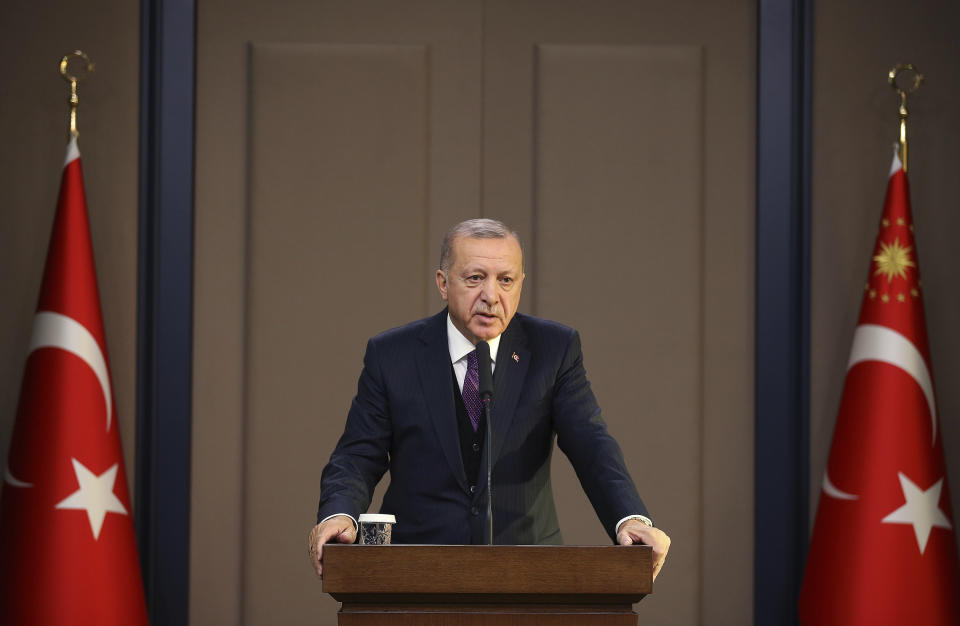 Turkey's President Recep Tayyip Erdogan speaks before departing to attend a NATO leader's summit in London, in Ankara, Turkey, Tuesday, Dec. 3, 2019. Erdogan says there is no change in Turkey's position that is holding up a NATO defense proposal for Poland and Baltic nations until the alliance supports Ankara's concerns related to Syrian Kurdish fighters. (Presidential Press Service via AP, Pool)