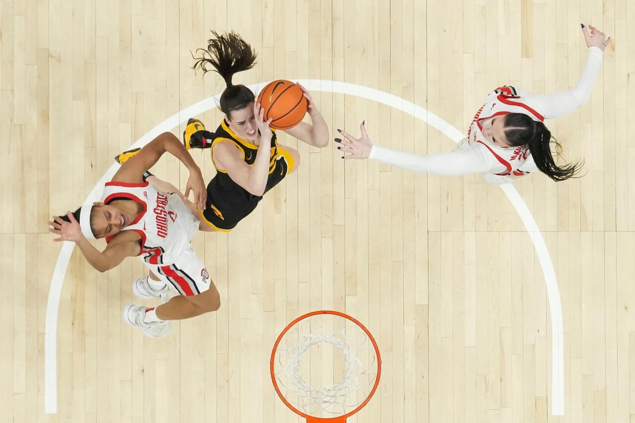 Iowa's Caitlin Clark, middle, scored 45 points against Ohio State earlier this year, but the Buckeyes won in overtime 100-92.