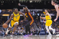 Indiana Pacers forward Jarace Walker (5) drives on Atlanta Hawks forward AJ Griffin (14) during the second half of an NBA basketball game in Indianapolis, Sunday, April 14, 2024. (AP Photo/Michael Conroy)