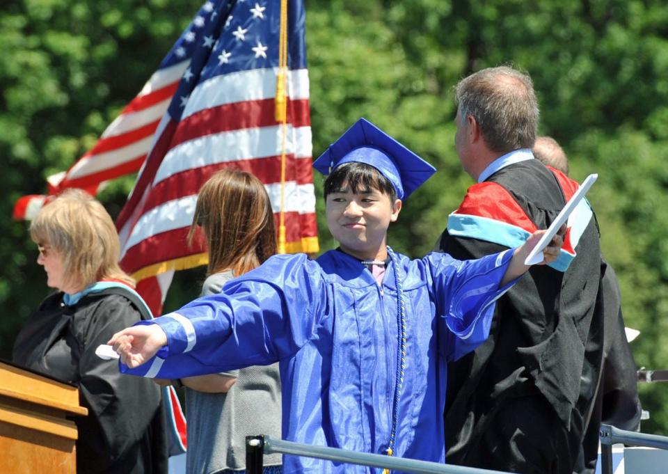 Brennan Loi celebrates receiving a diploma during the Braintree High School graduation Saturday, June 4, 2022.