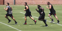 Atlanta Falcons' Alex Mack, Chris Lindstrom, James Carpenter and Kaleb McGary, from left, run sprints during the NFL football team's strength and conditioning workout Tuesday, Aug. 4, 2020, in Flowery Branch, Ga. (Curtis Compton/Atlanta Journal-Constitution via AP)