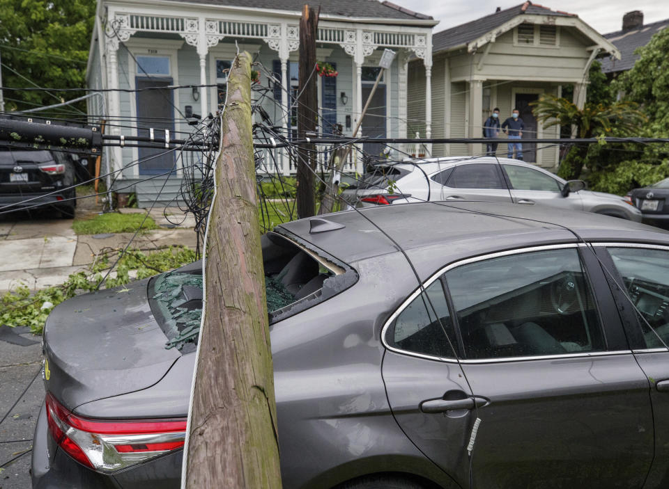 A utility pole rests on a 2020 Toyota Camry smashing the back window after powerful storms rolled through the city overnight, in New Orleans Wednesday, May 12, 2021. (David Grunfeld/The Advocate via AP)