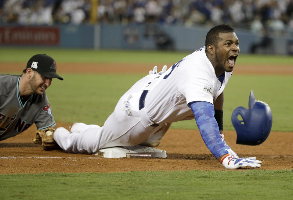 Los Angeles Dodgers’ Yasiel Puig celebrates after his triple against the Arizona Diamondbacks during the seventh inning of Game 1 of a baseball National League Division Series in Los Angeles, Friday, Oct. 6, 2017. (AP)