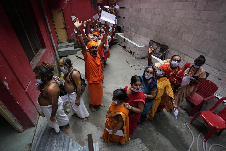 Hindu pilgrims, some chanting religious slogans, line up to register for an annual pilgrimage to the holy Amarnath cave, in Jammu, India, Saturday, July 9, 2022. At least 13 people were killed when sudden rains triggered flash floods during an annual Hindu pilgrimage to an icy Himalayan cave in Indian-controlled Kashmir on Friday, police said. (AP Photo/Channi Anand)