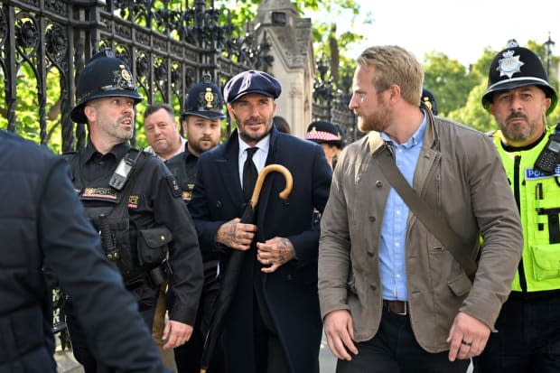 English former football player David Beckham leaves Westminster Hall, at the Palace of Westminster, in London on September 16, 2022 after paying his respects to the coffin of Queen Elizabeth II as it Lies in State. - Queen Elizabeth II will lie in state in Westminster Hall inside the Palace of Westminster, until 0530 GMT on September 19, a few hours before her funeral, with huge queues expected to file past her coffin to pay their respects. (Photo by Louisa Gouliamaki / AFP) (Photo by LOUISA GOULIAMAKI/AFP via Getty Images)<p><a href="https://www.gettyimages.com/detail/1243277479" rel="nofollow noopener" target="_blank" data-ylk="slk:LOUISA GOULIAMAKI/Getty Images;elm:context_link;itc:0;sec:content-canvas" class="link ">LOUISA GOULIAMAKI/Getty Images</a></p>