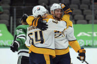 Nashville Predators center Mikael Granlund (64) celebrates the goal by Nashville Predators center Calle Jarnkrok (19) in the first period against the Dallas Stars during an NHL hockey game on Sunday, March 7, 2021, in Dallas. (AP Photo/Richard W. Rodriguez)