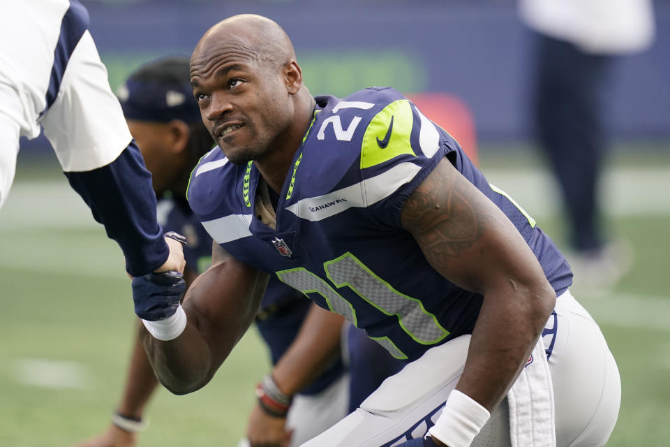 Seattle Seahawks running back Adrian Peterson is greeted during warmups before an NFL football game against the San Francisco 49ers, Sunday, Dec. 5, 2021, in Seattle. (AP Photo/Elaine Thompson)