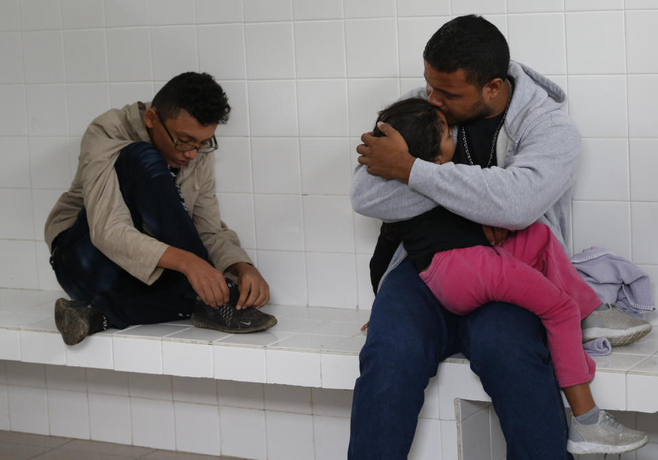 Honduran migrant Noe, 31, kisses his 4-year-old daughter Marlene as they wait inside an immigration holding cell after being removed from a bus heading north out of Comitan, Chiapas state, Mexico, Sunday, June 16, 2019. Mexican President Andrés Manuel López Obrador said Saturday his country must help Central Americans fleeing poverty and violence, even as it increases security and revisions to deter migrants from passing through Mexico on route to the U.S. (AP Photo/Rebecca Blackwell)