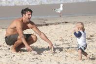 The hunky marketing manager from Sydney is all smiles as he plays on the beach with his little mate, enjoying the sun and showing off his tight rig.