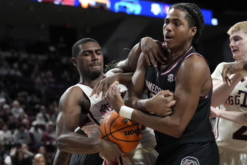 Texas A&M forward Henry Coleman III, left, and South Carolina forward Collin Murray-Boyles wrestle for the ball during the first half of an NCAA college basketball game Wednesday, Feb. 28, 2024, in College Station, Texas. (AP Photo/Sam Craft)