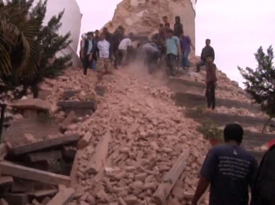 In this image from an AP video, people search among the rubble of buildings in Kathmandu after the earthquake hit the area on April 25, 2015. (AP video via AP)