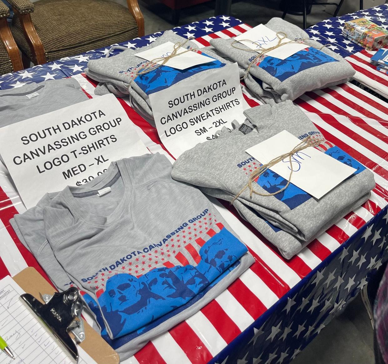 T-shirts for sale at a South Dakota Canvassing event at the Military Heritage Alliance in Sioux Falls, S.D., on Oct. 19, 2023. The group was formed after MyPillow founder Mike Lindell held his Cyber Symposium in Sioux Falls in August 2021.