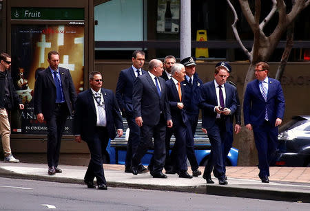 Australian Prime Minister Malcolm Turnbull walks with officials and security personnel along a street before holding a media conference announcing Australia's national security plan to protect public places in central Sydney, Australia, August 20, 2017. REUTERS/David Gray