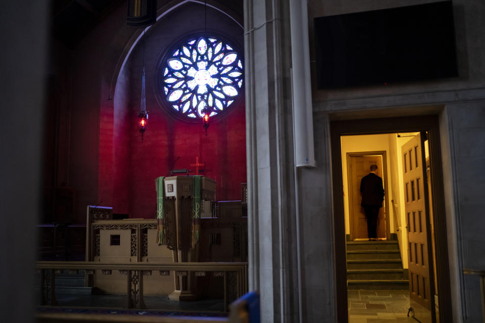 Rev. Stephen Cady walks into the sacristy at Asbury First United Methodist Church, Monday, Aug. 21, 2023, in Rochester, N.Y. Well-funded and well-attended, Asbury is a neogothic landmark in a neighborhood not far from downtown, sharing its street with the mansion built for Kodak founder George Eastman. It is roughly 3 miles (5 kilometers) from poorer neighborhoods north and west where most of the city’s shootings take place. (AP Photo/David Goldman)