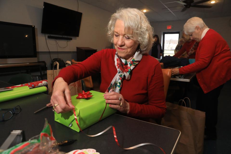 Celia Serotsky, president of the Poughkeepsie branch of the American Association of University Women wraps a donated Christmas gifts on December 16, 2022. The AAUW received $900 from Holiday Helping Hand to purchase two books for each of the children currently living in Hudson River Lodging, transitional housing made available through Hudson River Housing.