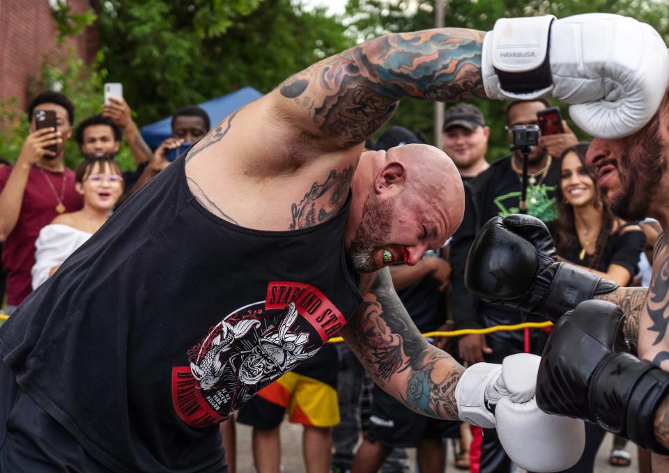 Ryan Rays, left, of Westland, launches himself at Jose Barba, of Detroit, while fighting during a Pick Your Poison Detroit event in Detroit's Delray neighborhood on Sunday, June 19, 2021.