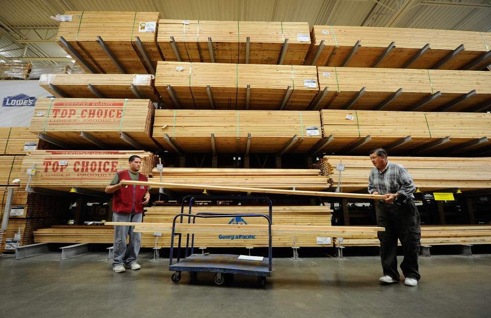 BURBANK, CA - APRIL 11:  Nick Teichtmann (R,) with the help of Lowe&#39;s employee Jaime Solis, buys lumber to renovate his house by adding a gazebo on top of a deck and fixing his garage at Lowe&#39;s home improvement store on April 11, 2011 in Burbank, California. Home improvement market sees uptick in business as new housing market continues to be slow. Lowe&#39;s reported their spring seasonal hiring at  is up 15 percent as homeowners tackle maintenance projects delayed during the recession.  (Photo by Kevork Djansezian/Getty Images)