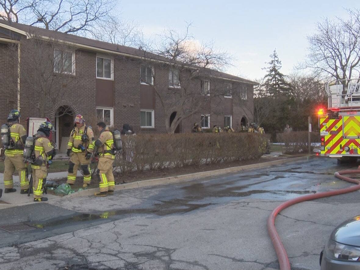 Emergency crews respond to fire at a residence in Oakville at approximately 6:20 p.m. Saturday. A female and a dog were found dead inside the building. (CBC - image credit)