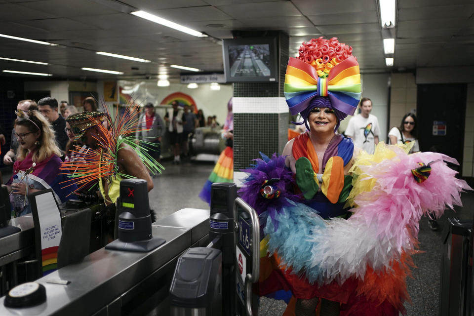 People arrive at Hyde Park underground station to take part in the Pride in London parade, Saturday July 1, 2023. (Jordan Pettitt/PA via AP)