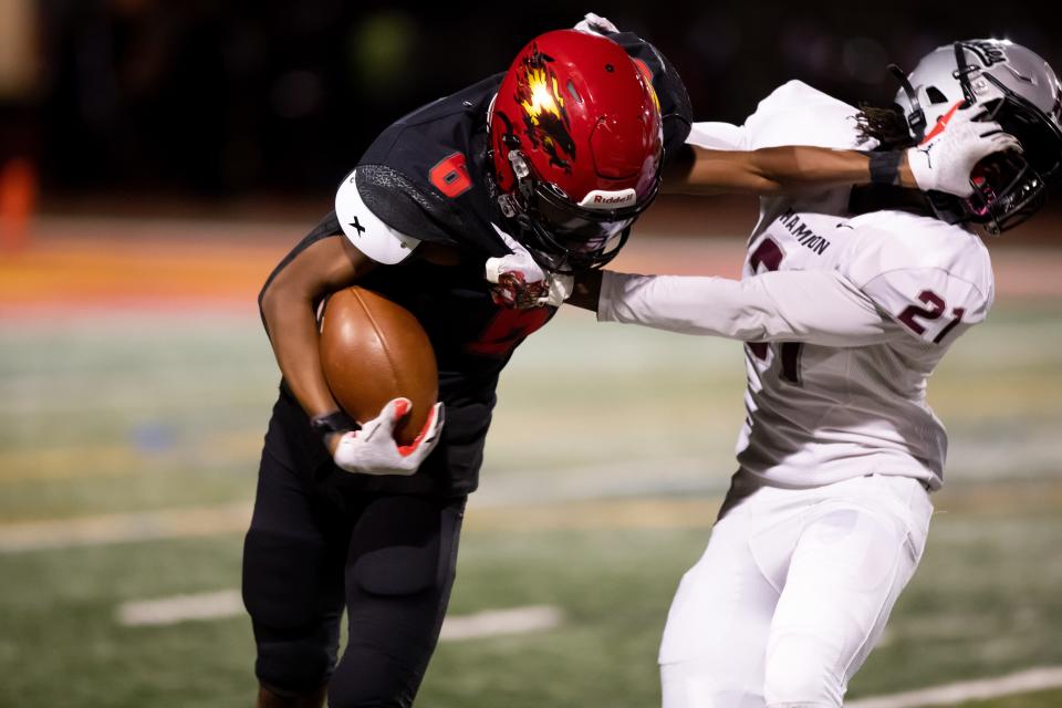 Hamilton football's Emyson Edmonds (#21) makes a tackle on Chaparral's Plas Johnson (#6) during a kick-off in Chandler on Oct. 8, 2021.