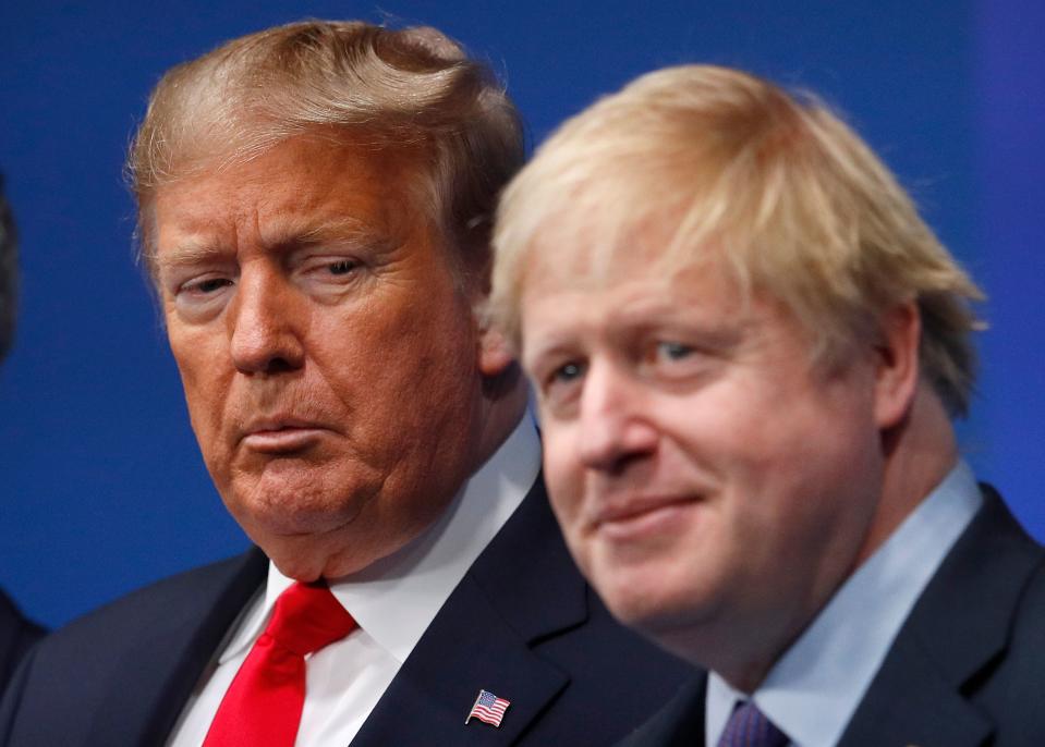 TOPSHOT - Britain's Prime Minister Boris Johnson (R) welcomes US President Donald Trump (L) to the NATO summit at the Grove hotel in Watford, northeast of London on December 4, 2019. (Photo by PETER NICHOLLS / various sources / AFP) (Photo by PETER NICHOLLS/AFP via Getty Images)