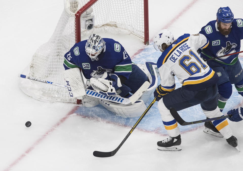 Vancouver Canucks goalie Jacob Markstrom (25) makes the save on St. Louis Blues' Jacob de la Rose (61) during the second period of an NHL Western Conference Stanley Cup playoff series, in Edmonton, Alberta, Friday, Aug. 21, 2020. (Jason Franson/The Canadian Press via AP)