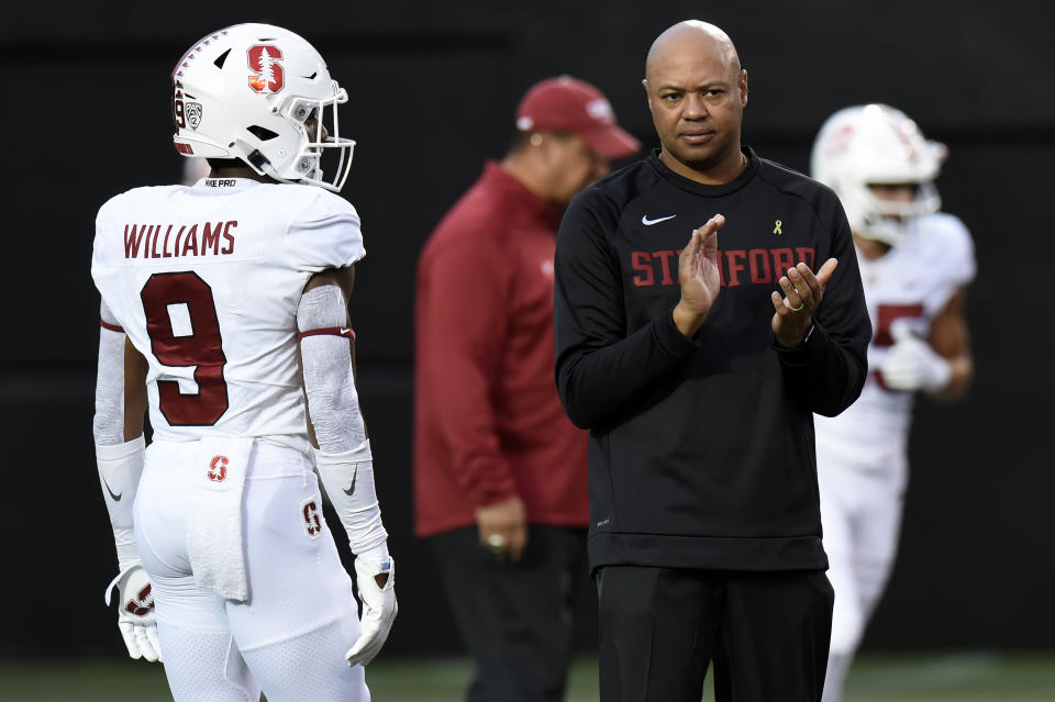 Stanford head coach David Shaw, right, watches players warm up before an NCAA college football game against Vanderbilt, Saturday, Sept. 18, 2021, in Nashville, Tenn. (AP Photo/Mark Zaleski)