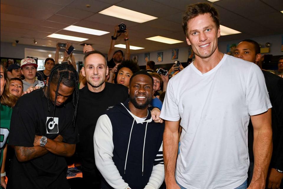 <p>Dave Kotinsky/Getty </p> Travis Scott, Michael Rubin, Kevin Hart and Tom Brady attend Fanatics and Topps 