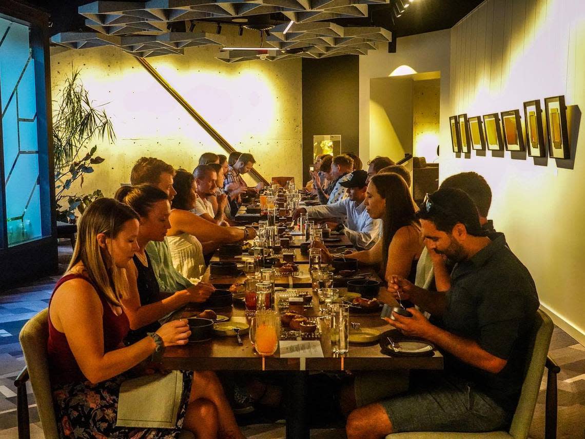 Diners enjoy a meal during a soft opening event at Kin’s new tasting room in Boise.