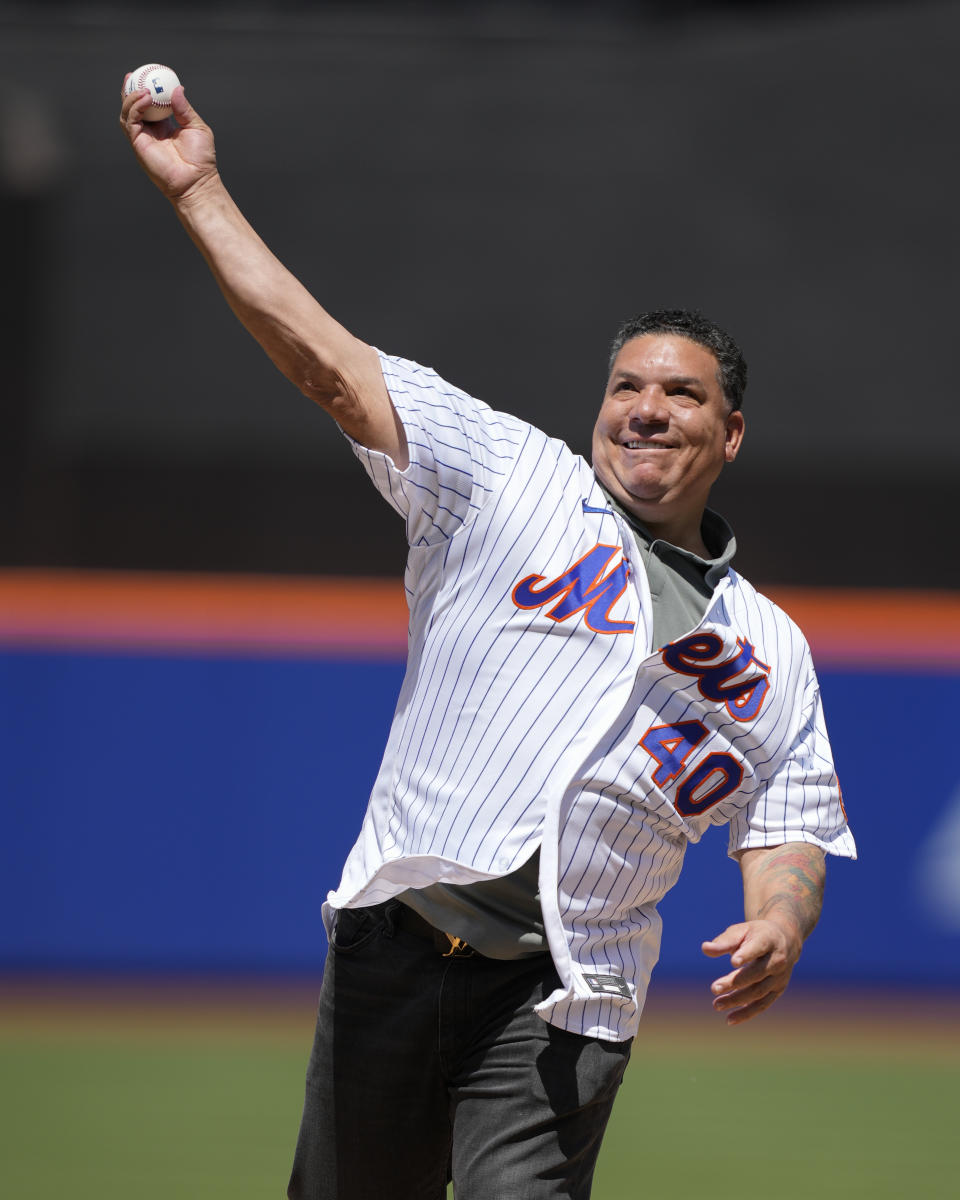 Former New York Mets pitcher Bartolo Colon throws the ceremonial first pitch before a baseball game against the Colorado Rockies, Sunday, May 7, 2023, in New York. (AP Photo/John Minchillo)