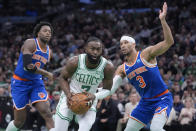 Boston Celtics guard Jaylen Brown (7) drives toward the basket in front of New York Knicks forward OG Anunoby (8) and guard Josh Hart (3) during the first half of an NBA basketball game Thursday, April 11, 2024, in Boston. (AP Photo/Steven Senne)