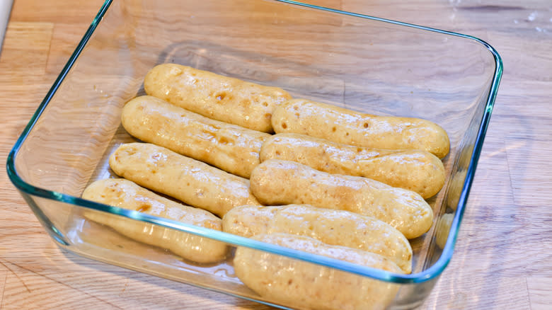 adding lady fingers baking dish