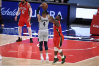 Washington Wizards guard Russell Westbrook (4) shoots against New Orleans Pelicans forward Zion Williamson, right, late in the overtime of an NBA basketball game Friday, April 16, 2021, in Washington. Williamson was called for a foul on the play. (AP Photo/Nick Wass)