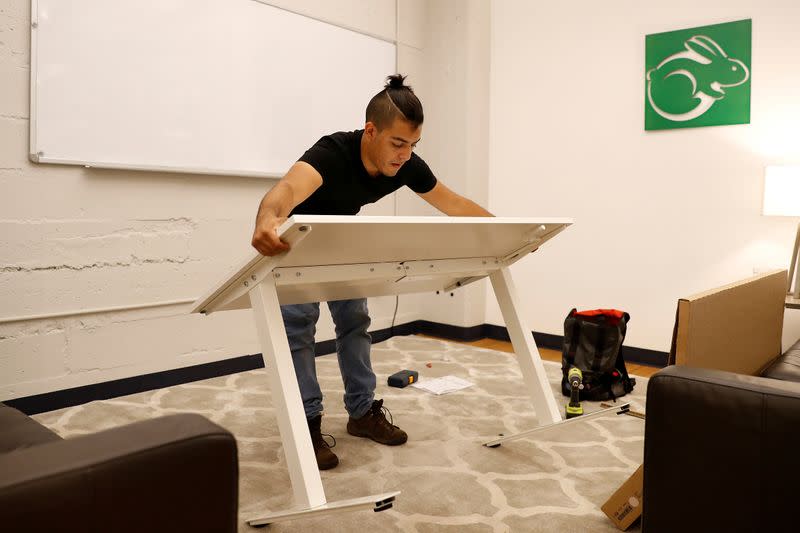 FILE PHOTO: TaskRabbit Tasker Guillermo Rodriguez assembles an IKEA table at the TaskRabbit office in San Francisco, California