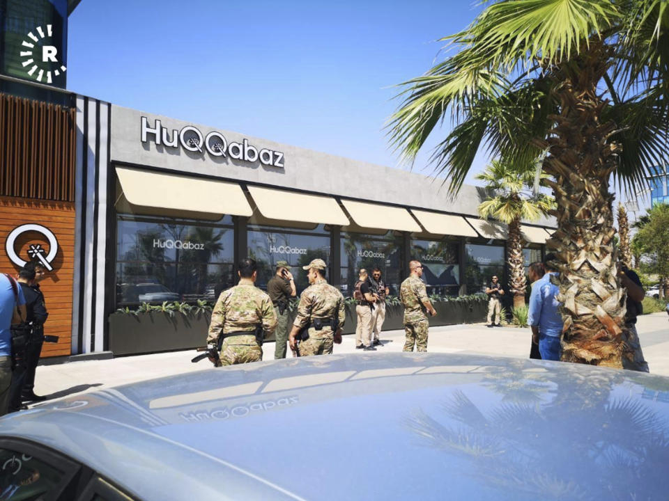 This image posted by RUDAW Facebook TV, an Irbil-based Kurdish broadcaster, shows security forces at the scene of a shooting outside a restaurant in Irbil, Iraq, Wednesday, July 17, 2019. Turkey's state-run news agency says a Turkish diplomat working at Ankara's consulate in the northern Iraqi city of Irbil was killed during a shooting attack inside the restaurant there. (RUDAW Facebook TV via AP)