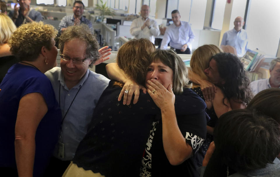 Staff of the South Florida Sun Sentinel celebrate their bittersweet honor Monday, April 15, 2019, in Deerfield Beach, Fla., after winning the Pulitzer Prize for Public Service. The newspaper won for its coverage of the Parkland school shooting. (Carline Jean/South Florida Sun-Sentinel via AP)