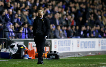 Soccer Football - FA Cup Fifth Round - Wigan Athletic vs Manchester City - DW Stadium, Wigan, Britain - February 19, 2018 Manchester City manager Pep Guardiola looks dejected REUTERS/Andrew Yates