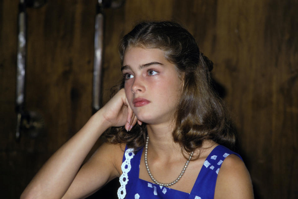 young brooke sitting with her face resting on her fist