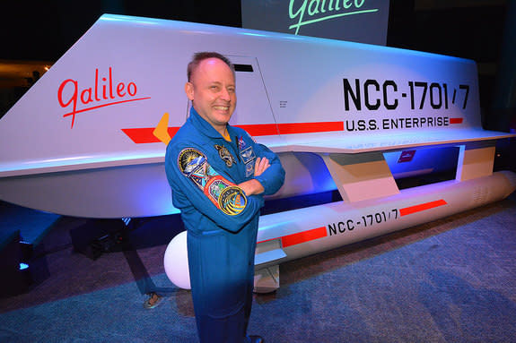 NASA astronaut Mike Fincke poses with the newly-revealed “Star Trek” Galileo shuttlecraft prop at Space Center Houston in Texas, July 31, 2013.