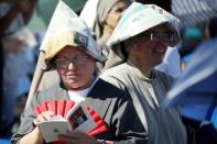 Believers are seen at the mass given by Pope Francis in Palermo on Saturday