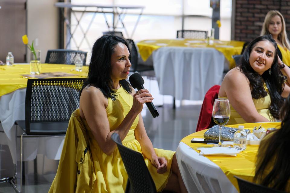 Claudia Luna, president of Historic Sixth Street on Route 66 Association, speaks about her experiences at AM de Amarillo's Mujeres de Amarillo (women in yellow) event last weekend in east Amarillo.