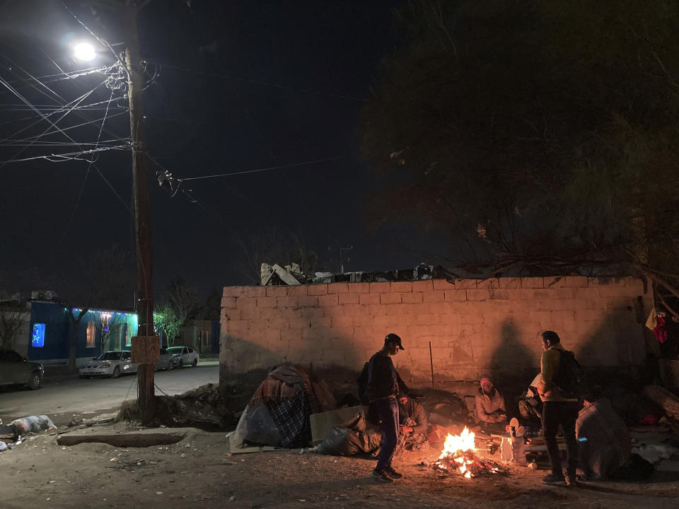 Venezuelan migrants crowd around an outdoor bonfire as temperatures plummet in Ciudad Juárez, Mexico, on Thursday, Dec. 22, 2022. Hundreds of migrants are gathered in unusually frigid cold temperatures along the Mexican-U.S. border near El Paso, Texas, awaiting a U.S. Supreme Court decision on whether and when to lift pandemic-era restrictions that prevent many from seeking asylum. (AP Photo/Morgan Lee)