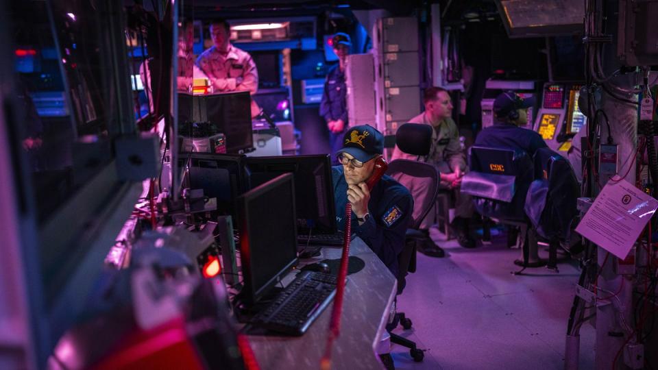 Crew members work in the combat information center aboard the Navy destroyer Gravely on Feb. 13, 2024, in the Red Sea. (Bernat Armangue/AP)