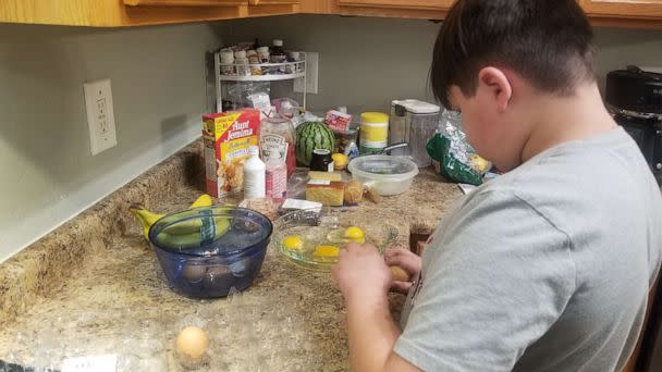 PHOTO: Jojo Branch-Rodriguez, a 12-year-old boy who is on the autism spectrum, cooks pancakes in Phoenix. (Maria Rodriguez)