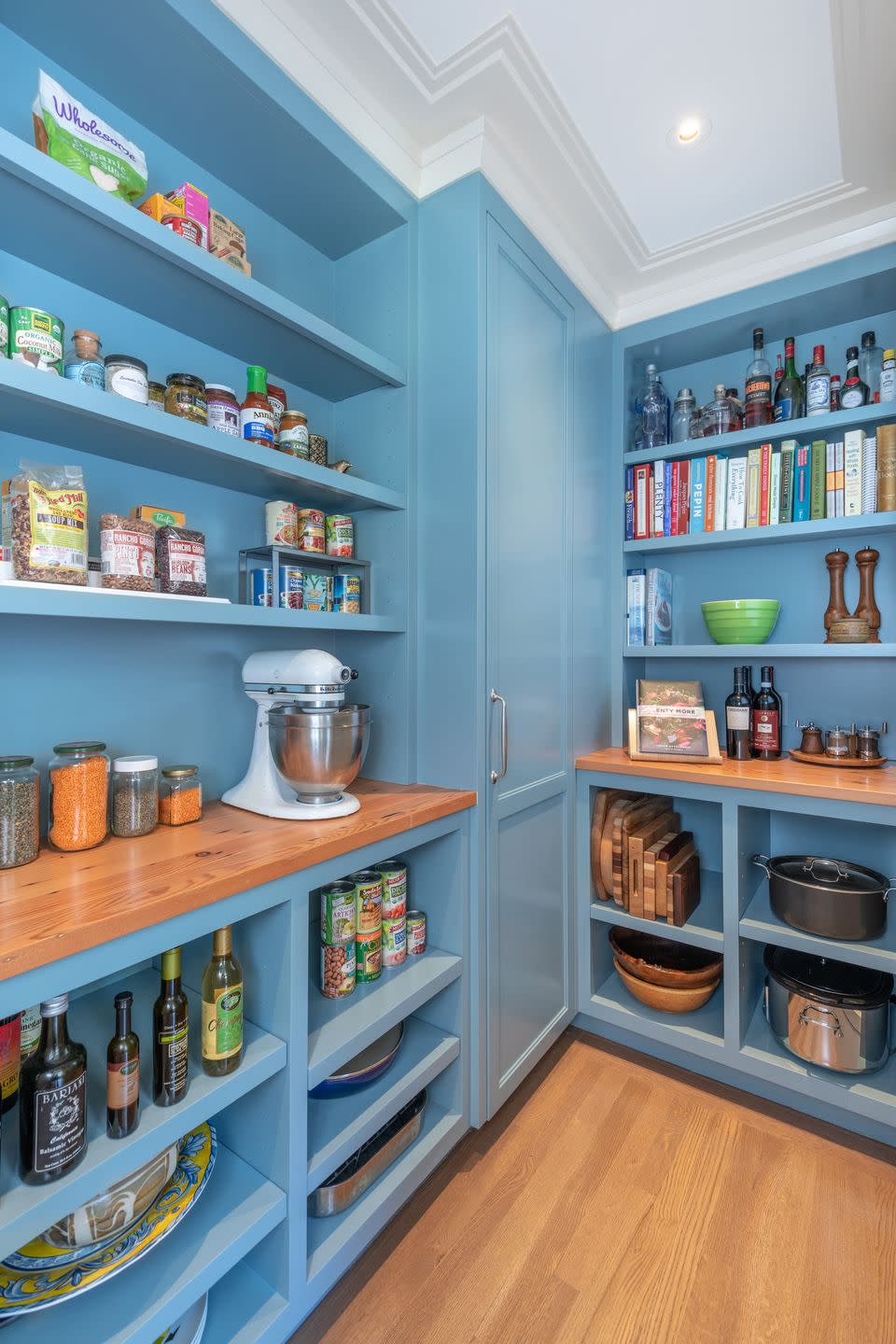 pantry organization ideas, bright blue painted walls in the pantry with wood countertops