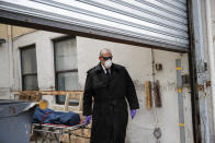 Funeral director Tom Cheeseman collects a body from a nursing home, Friday, April 3, 2020, in the Brooklyn borough of New York. He wears the shades for every call, even when it’s gray and rainy. He likes that light seeps into his peripheral vision, no matter how dreary. (AP Photo/John Minchillo)