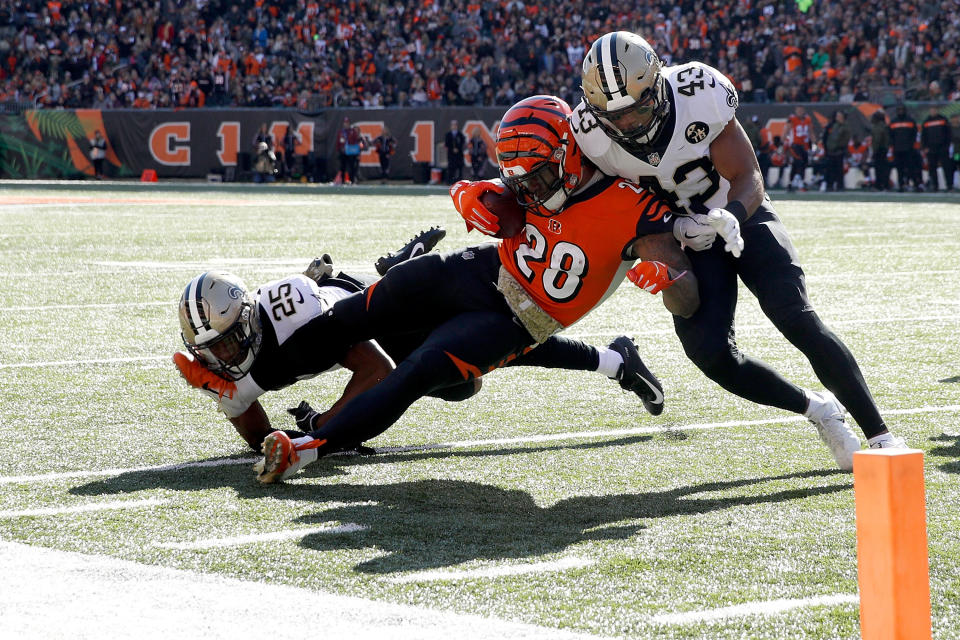 <p>Joe Mixon #28 of the Cincinnati Bengals is tackled by Eli Apple #25 of the New Orleans Saints and Marcus Williams #43 during the first quarter at Paul Brown Stadium on November 11, 2018 in Cincinnati, Ohio. (Photo by Joe Robbins/Getty Images) </p>